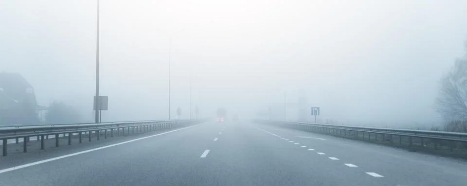 Driver POV on almost empty blue foggy misty rainy highway intercity road with Фото