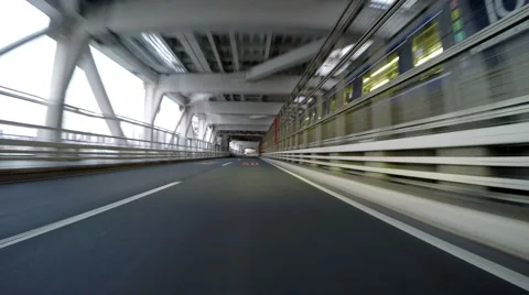 Driver POV through the empty lower deck of Rainbow Bridge along Yurikamome Stock Footage 61863586