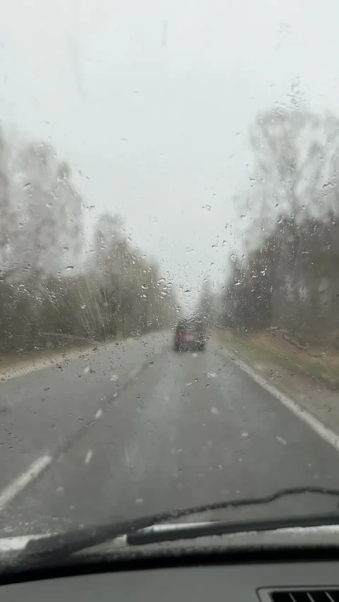 Driver POV Through Windshield in Wet Snow with Wipers Cleaning Stock Footage 333818746
