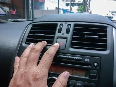 Driver pressed the emergency light in the car. Stock Photos