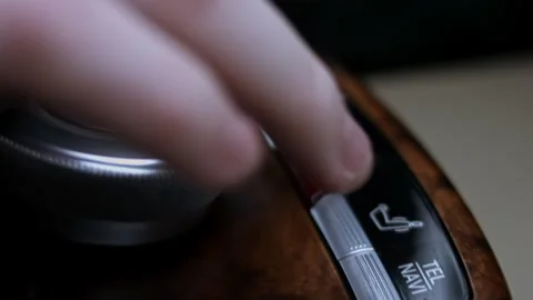 Driver presses the hazard warning button on the shiny dashboard of the car. The Stock Footage 323312017