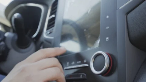 The driver presses the touch screen in the car. The man thumbs the menu Video stock 89000492