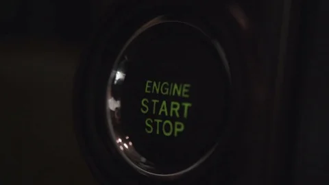 Driver pressing an automatic start button Stock Footage 71535011