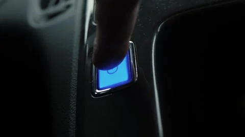 Driver pressing blue power button Stock Footage 336409114