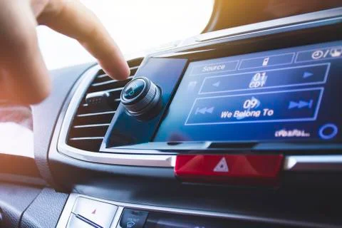 Driver pressing power button of car radio Foto stock