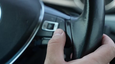 Driver Pressing Steering Wheel Control Button in Modern Car Stock-Footage 343157022
