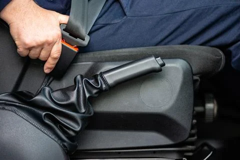 Driver pulling handbrake in car interior photo 스톡 사진