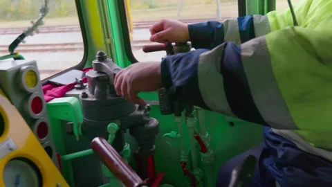 Driver pulls levers and operates the train inside a cabin, midshot, Video stock 241392940