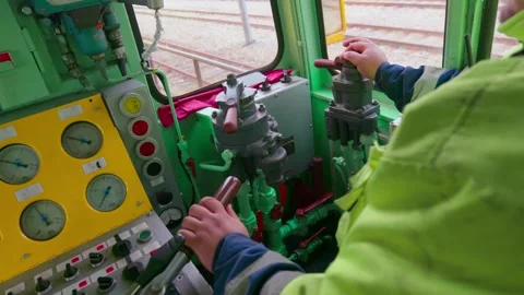 Driver pulls levers and operates a moving train, inside cabin, midshot, Video stock 241395141