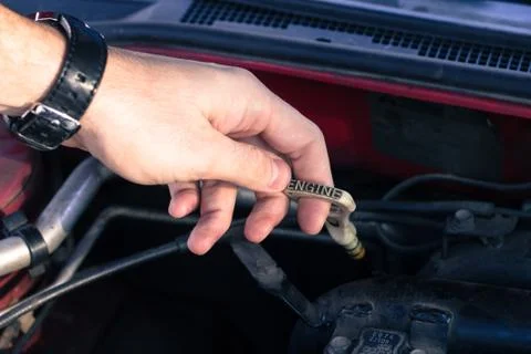 Driver pulls out an automobile dipstick Foto stock