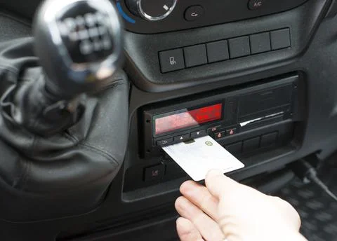 Driver pulls out the driver card from a digital tachograph Stock Photos