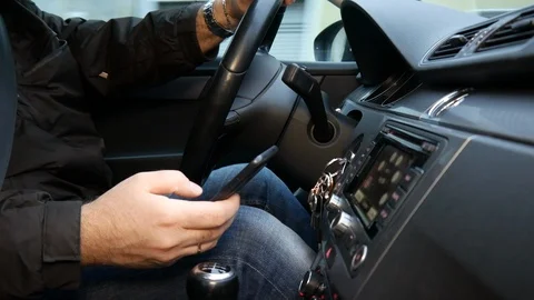 The driver pulls the phone while driving. Close-up 1 Stock Footage 86064543