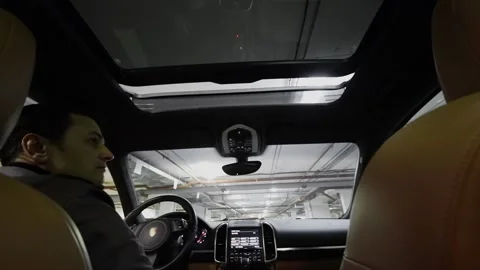 Driver pushes button and closes roof window in car Stock Footage 299665143