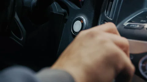 Driver pushing car engine start stop button Vidéo 325070615