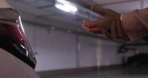 Driver puts on and adjusts gloves to change rubber on car Stockbeeldmateriaal 294607786