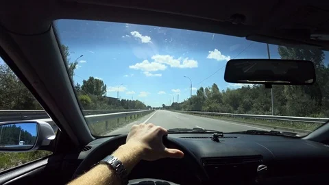 The driver quickly goes by car on the highway, overtakes other cars from the fir Video stock 107072596