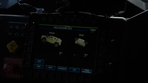 Driver reading onboard inclinometer screen on new joint light tactical vehicle Vídeos de archivo 104601215