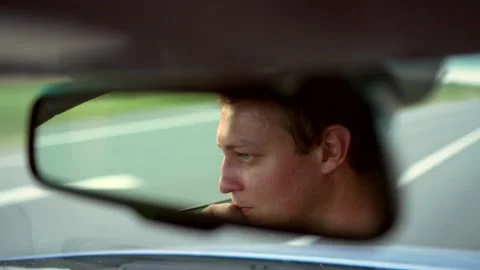 Driver in the rearview mirror Stock Footage 135922838