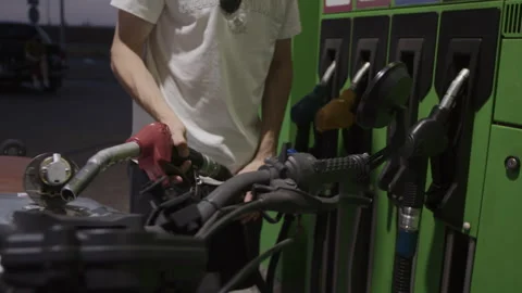 A driver refueling his motorcycle at a gas station Video stock 253447469