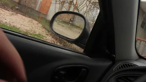 Driver is regulating car's side mirror by the hand for the safe driving Stock Footage 48846738
