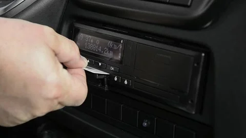 Driver removing smart chip card from tachograph slot Stock Footage 340077973