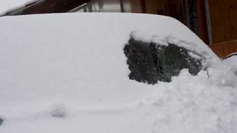 Driver removing snow from car windshield, close-up Stock Footage 255022490