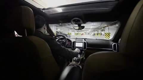 Driver rides backward in car in underground Stock Footage 299665040