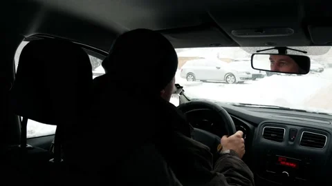 Driver rides in a car in winter cold snowy weather with a wet windshield  Stock Footage 236688445
