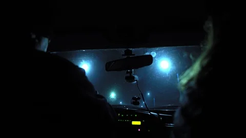 Driver rides at night on a lighted road. Inside view. Headlights light the way. Stock Footage 123178707