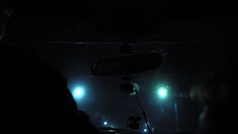 Driver rides at night on a lighted road. Inside view. Headlights light the way. Stock Footage 123399967