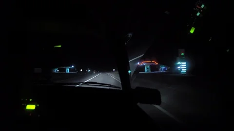 Driver rides at night on a lighted road. Inside view. Headlights light the way. Stock Footage 123399974