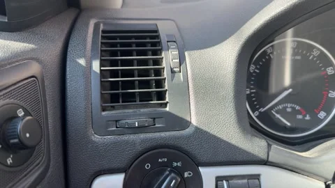 Driver rotates the dashboard light switch to select headlights, parking lights Stock Footage 337114979