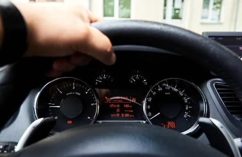 Driver s hand on a steering wheel inside of a car Driver s hand on a steer... Stock Photos