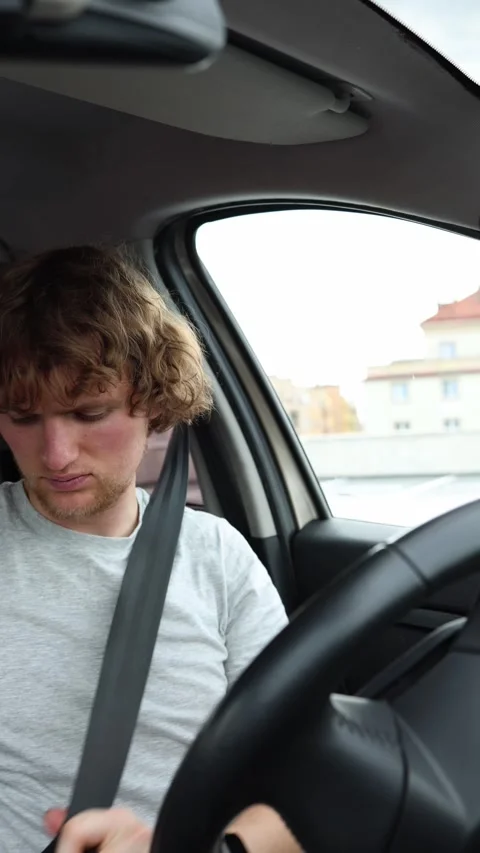 Driver secures the seat belt before starting the car and beginning the journey Stock Footage 342919325