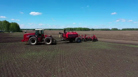 Driver of the seeding machine checks the level of fertilizer and grain Stock Footage 130521669