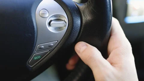 Driver sets up the cruise control of an autonomous car while driving down the Stock Footage 196002956