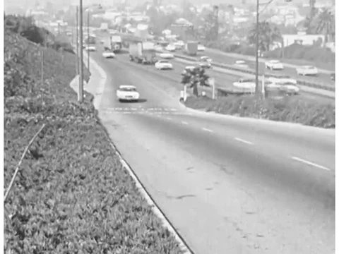 A driver is shown driving on the freeway and in an intersection, in Los Angeles, Video stock 74998486