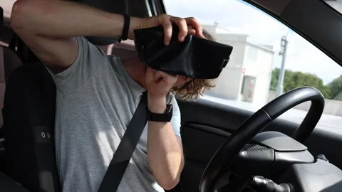 Driver shows empty wallet after spending money on costly car repairs Stock Footage 343719652