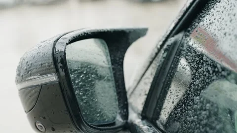 Driver side mirror covered with rain droplets while pouring rain. Stock Footage 243623923