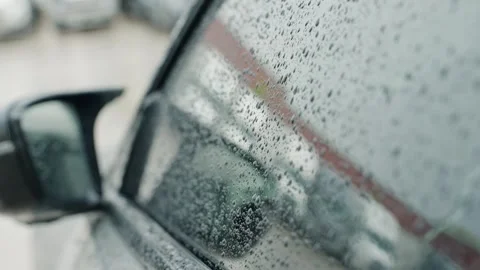 Driver side mirror covered with rain droplets while pouring rain. Stock Footage 243623929