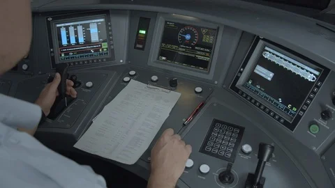 The driver sits in the cab of a high-speed train and presses the buttons Видео 123453013
