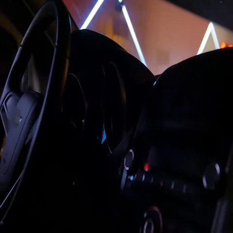 The driver sits in the car at night turns the ignition key starts its engine and Stock Footage 69669079