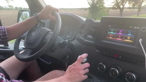 A Driver Skillfully Maneuvering a Van Equipped with a Touchscreen Display Stock Footage 315809661