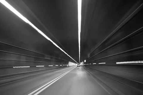Driver speeding through dark highway tunnel with motion blur Stock Photos