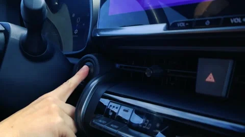 Driver starting an electric car engine with a push button Stock Footage 346595094