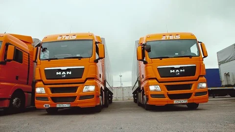 Driver starts motion of the cargo TIR transportation truck from parking lot Stock Footage 83418147