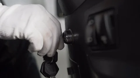 Driver starts vehicle with a bunch of keys in his hand. Dipped, main beam blinks Stock Footage 128691608
