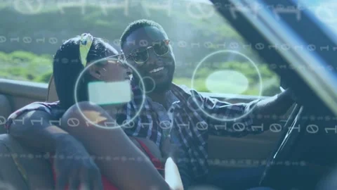 Driver steering, passenger leaning laughing, driving causing app icons fading Stock Footage 333552999