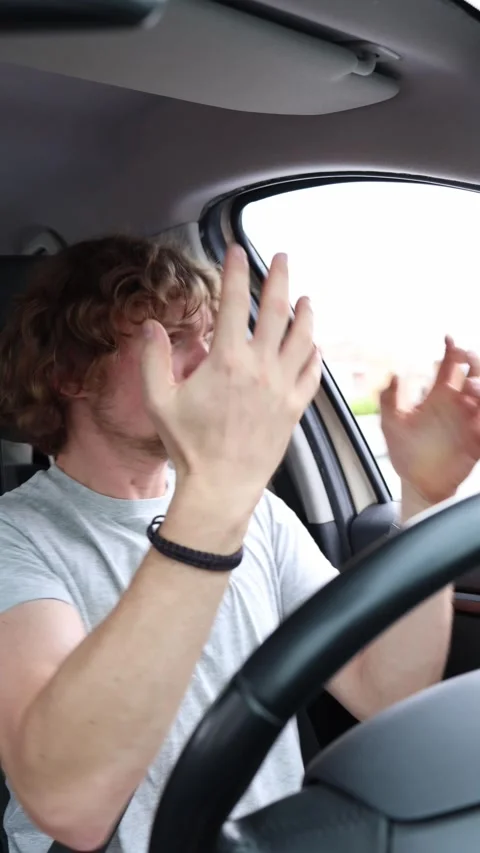 Driver stops his car opens the window and angrily shouts outside Stock Footage 342922126