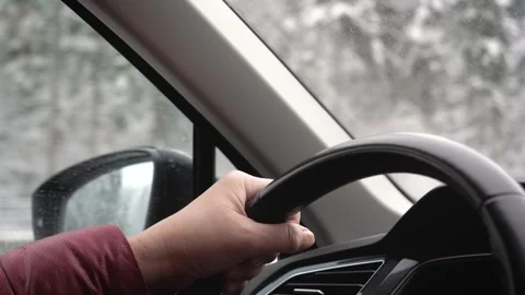 Driver strategically positions hands for safety on icy winter roads Stock-Footage 322115371